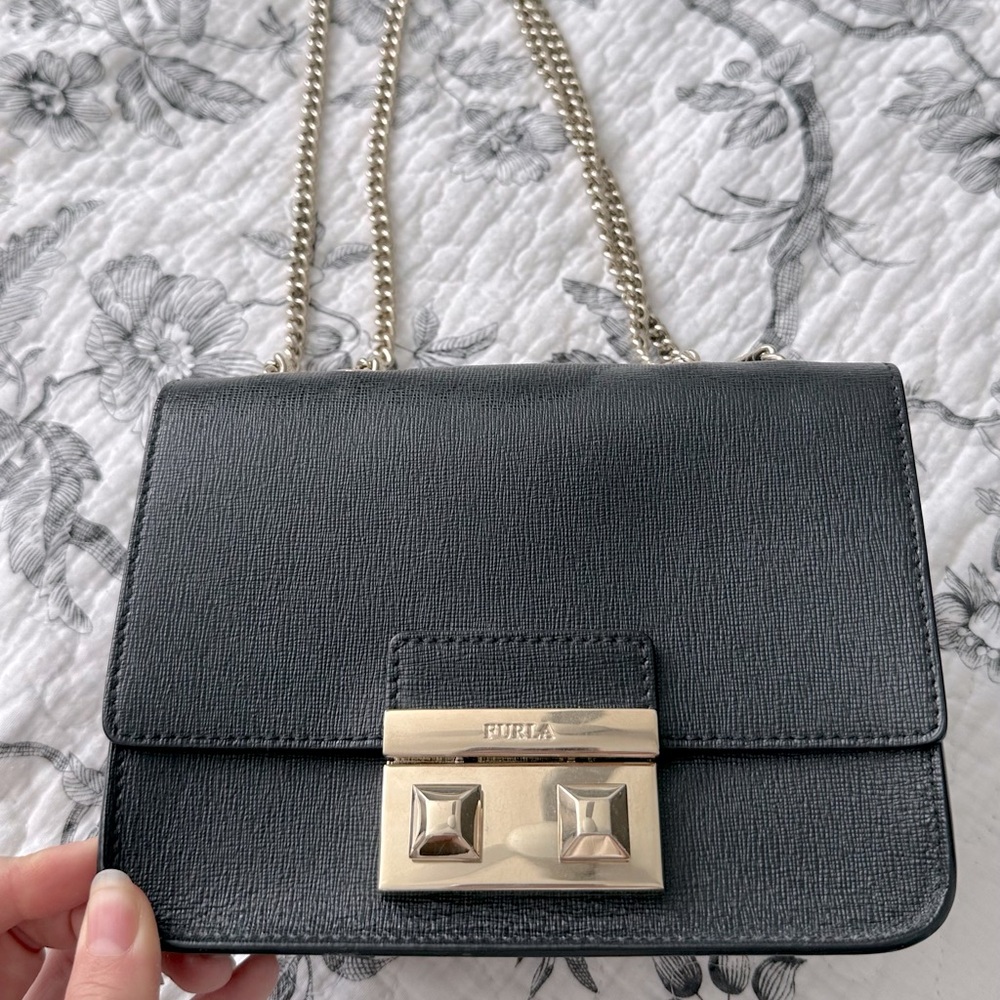 Black leather Furla clutch with gold accents